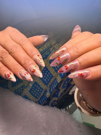 A delicate and artistic floral design. This set features hand-painted red and green sprigs on a sheer, glossy base for a look that is both subtle and beautiful.