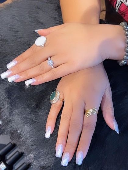 A full set of brilliant white glitter nails that sparkle from every angle. A perfect party or wedding design.