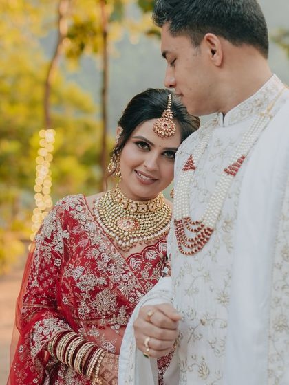 A close-up portrait of the bride resting her head on the groom's shoulder, a quiet and intimate moment of togetherness.