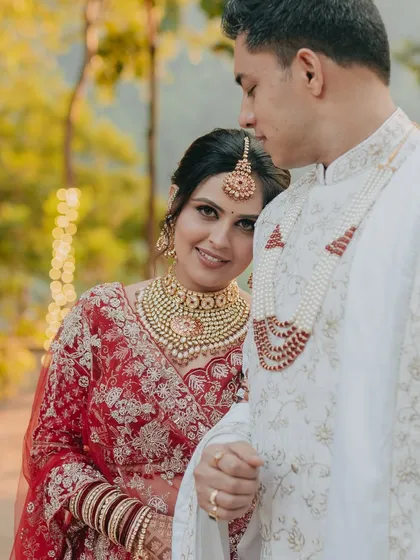 A tender moment where the bride rests her head on the groom's shoulder. This portrait captures the quiet comfort and trust between the couple during their beautiful hill wedding.