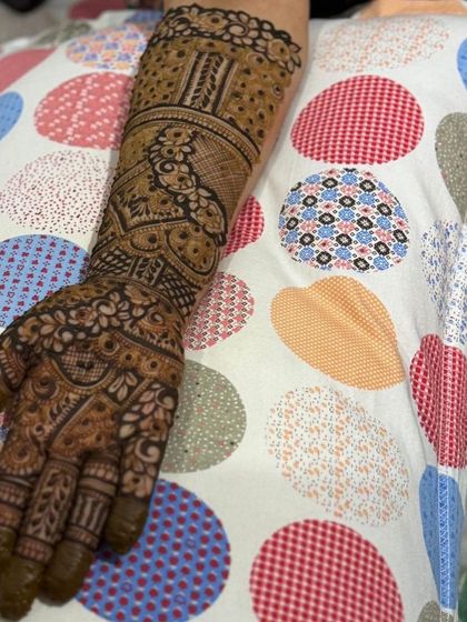 A full-arm design with intricate bands and patterns.