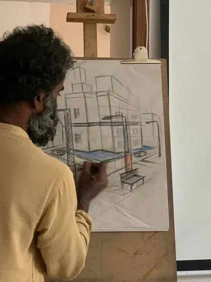 Here, a mentor demonstrates the principles of perspective drawing. Our teaching is hands-on and direct, focusing on imparting the technical skills and observational discipline necessary to translate three-dimensional space onto a two-dimensional surface.