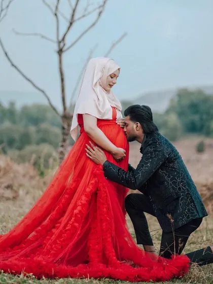 Another beautiful angle from this outdoor shoot, showcasing the full view of the red ruffled trail gown. It shows how a single dress can create so many different, stunning photo opportunities for a couple.