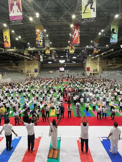 Our stadium is more than just a sports arena; it's a community hub. This wide angle shot shows our venue hosting a massive International Yoga Day event, demonstrating our capacity to accommodate large scale wellness and corporate gatherings.