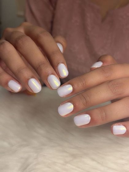 Simple and clean white chrome nails for a glazed donut look on short, natural nails.