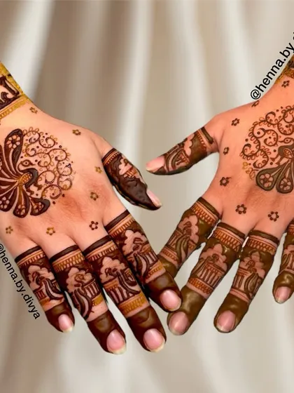A playful and elegant design featuring peacock fan mandalas on the palms. The cuffs are decorated with a line of elephants, adding a touch of royal charm.