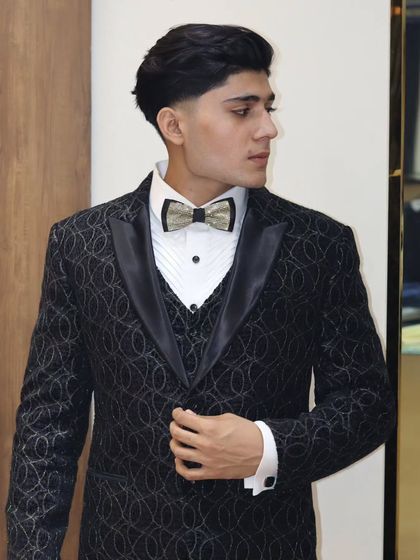 A client looking dapper in his custom black patterned tuxedo. The fit, the fabric, and the style all come together to create a look of pure confidence.