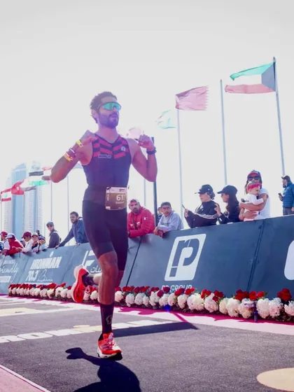 Running towards the finish with the crowd cheering on. The final leg of a triathlon tests an athlete's endurance, and our community is there to support them all the way.