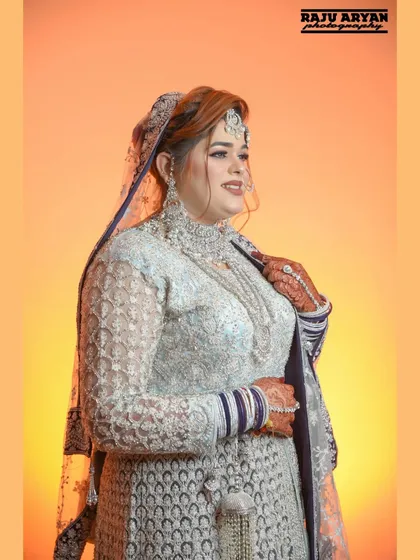 The bride glances away with a happy smile. This candid-style portrait captures a moment of genuine joy and excitement on her special day.