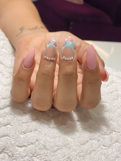 A beautiful set of matte pink nails with a delicate heart and pearl design, created by my student Ramandeep from Punjab. This showcases her skill in gel extensions and detailed art.