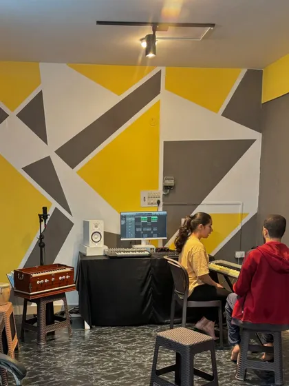 A student receives one-on-one guidance during a music production class at our Kaggadasapura studio. We focus on practical learning, using keyboards and software to bring musical ideas to life.