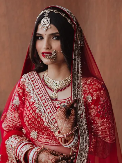There is a unique power in a classic red lip. This close-up shows how a perfectly applied bold red lipstick can define a bridal look, making it both timeless and unforgettable.