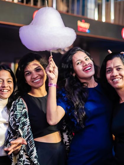 Friends enjoying the complimentary cotton candy, a unique perk of my Tuesday Ladies' Night. It’s these small details that make the night memorable and fun.