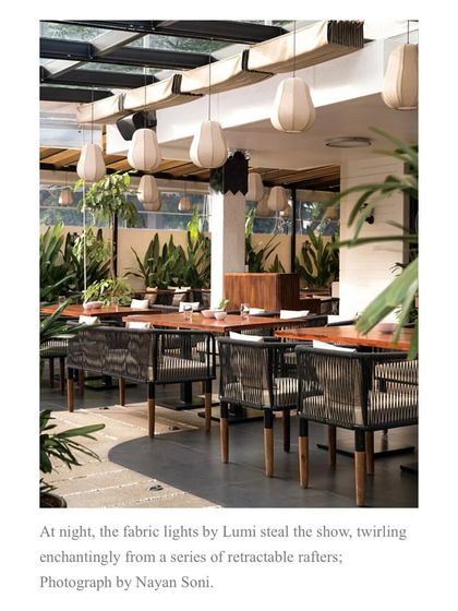A second shot from the feature, emphasizing the enchanting effect of the custom fabric lights in the restaurant's outdoor seating area.