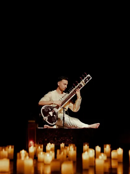 A solitary moment on stage, just me and the sitar surrounded by light. This image captures the essence of the 'Sitar for Mental Health' mission: finding the light within through music.