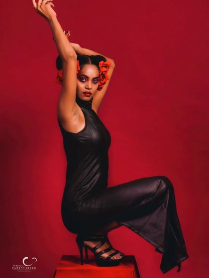 A creative and unconventional seated pose that feels like a high-fashion editorial. The composition is bold and memorable.