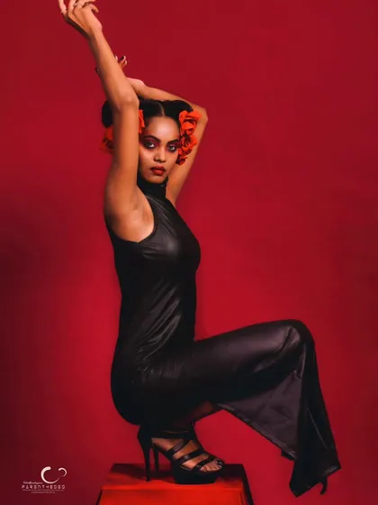 A creative and unconventional seated pose that feels like a high-fashion editorial. The composition is bold and memorable.