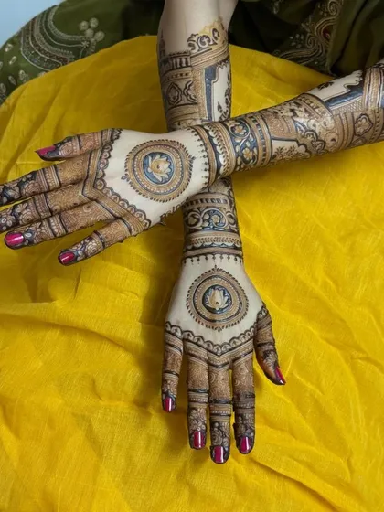 A striking design with lotus mandalas on the back of the hands, connected to full-arm pieces with divine figures.