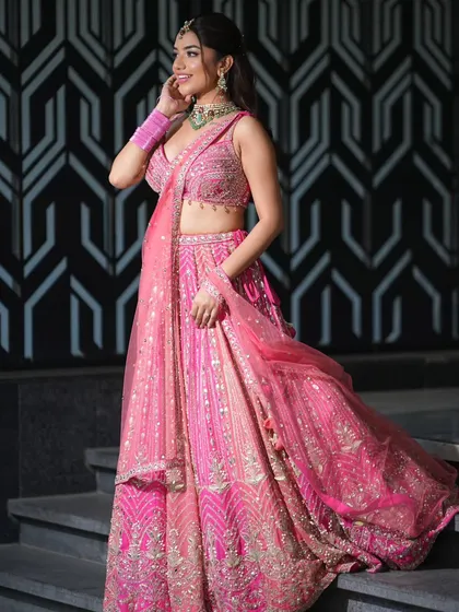 The way this lehenga and dupatta catch the light is just beautiful. The drape is designed to create dimension and movement, adding to the overall glamour.