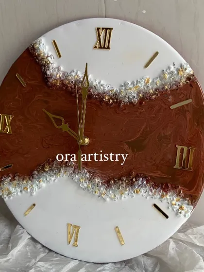 A classic geode-style clock with rich brown and white resin, accented with clear and gold crystals.