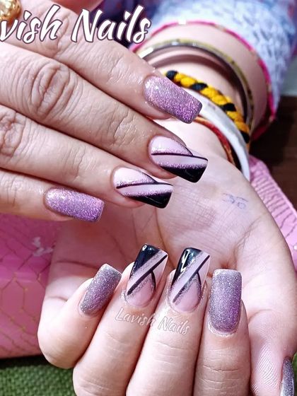 A mix of purple glitter and abstract black-on-nude designs for a modern, edgy look.