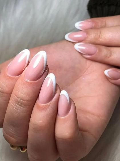 Another view of the classic almond-shaped French manicure, highlighting the glossy finish and perfect curves.