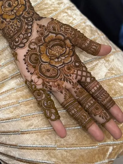 A close-up of the palm, showing the detailed flower and finger work.