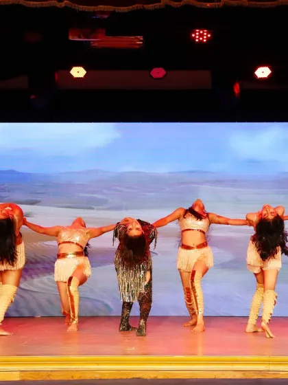 A powerful, synchronized pose from our jazz funk performance. We train our students in precision and performance quality, ensuring every moment on stage is impactful.