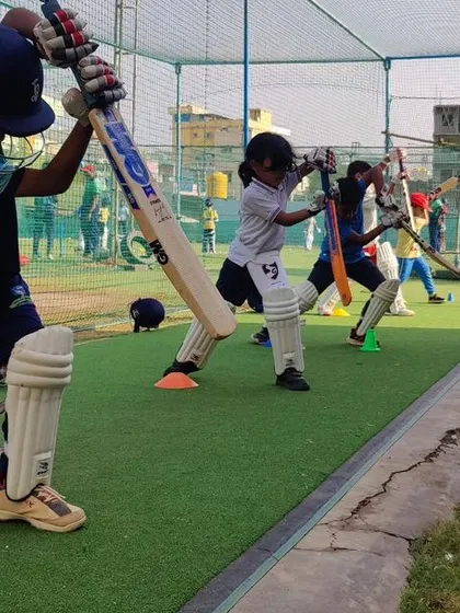 A close-up shot of a young batsman practicing his drive. We focus on getting the fundamentals right, like a high elbow and a straight bat.