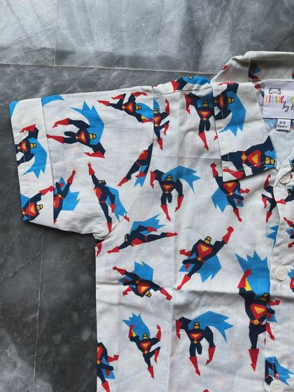 A detailed shot of our Superman print. The colors are vibrant and the cotton is so soft, ensuring your little one feels like a superhero all day.