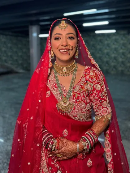 The pure joy of a bride on her wedding day. Sona's smile says it all. Her makeup was kept classic and radiant to match her vibrant red saree.