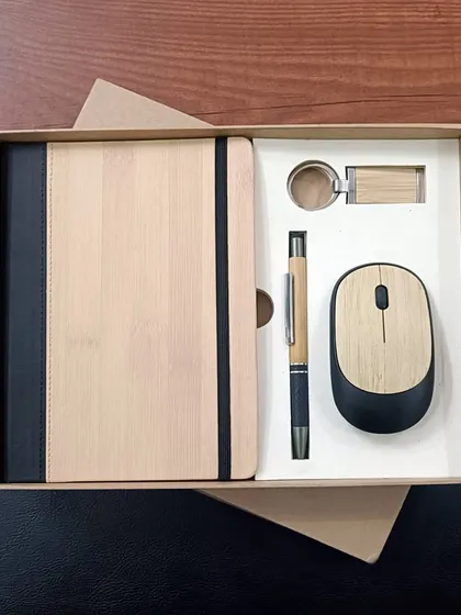 Another look at my popular eco-friendly welcome kit. This set features a bamboo-covered notebook, a matching pen and keychain, and a wireless mouse, perfect for companies looking to make a green statement.