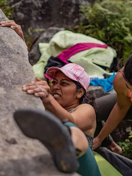 Another angle of the same powerful moment, showing the support from her fellow climber.