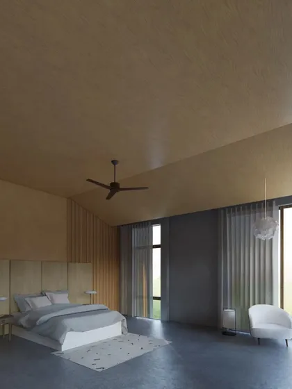 The master bedroom in the Sanctuary Residence is a spacious, serene retreat with a vaulted wood-paneled ceiling and large windows that frame views of the open landscape.