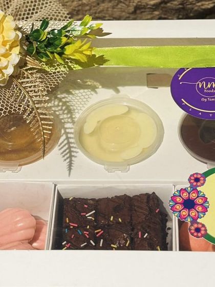 The Exotic Dessert Box, all packed up and ready for a "Happy Rakhi" celebration. A sweet treat for a special bond.