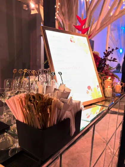 A view of our mirrored bar setup, highlighting the custom stirrers and backlit menu. Every detail is carefully planned to create a cohesive and elegant look.