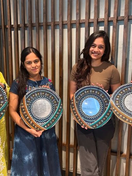 Four participants showcasing their stunning, unique mandala mirrors. Each piece reflects the artist's personal style and color choices, making it a truly special creation.