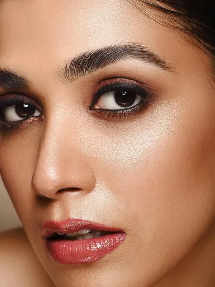 This is a more intense take on the smokey eye look. The direct gaze and tight framing create a powerful connection with the viewer, making it a compelling image for a fashion or beauty feature.