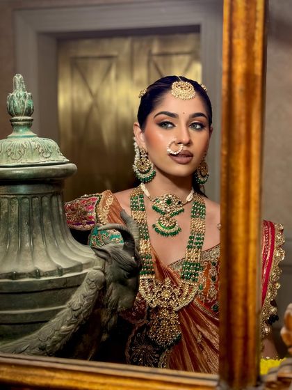 A reflection of elegance. This shot captures the regal feel of the South Indian bridal look, with perfectly defined features and glowing skin.