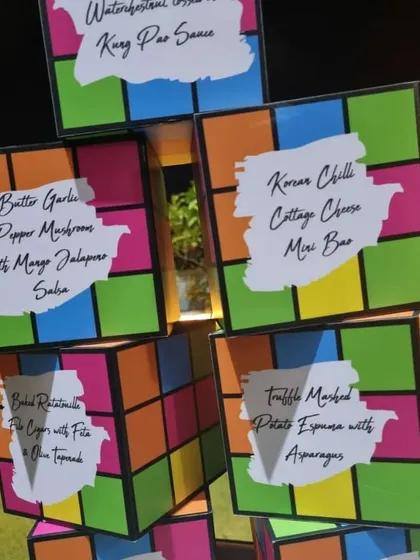 We love a good theme. For this party, we created custom menu signs designed like Rubik's cubes to display our offerings, such as Korean Chilli Cottage Cheese Mini Baos and Truffle Mashed Potato Espuma.