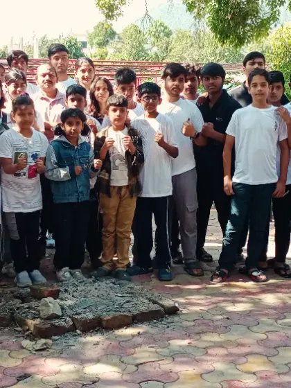 The whole team together before heading back from a successful summer camp. You can see the bonfire pit we used, a sign of the camaraderie we built.