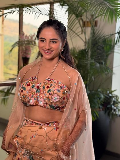 The bride looking radiant and happy in her Haldi outfit. The natural light enhances her glowing skin and the soft colors of her makeup.
