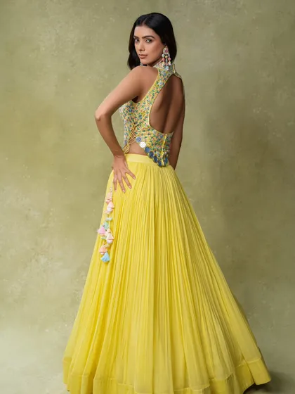 A back-view shot of a yellow lehenga, highlighting the open-back design of the blouse. Providing multiple angles is crucial for giving online customers the confidence to purchase.