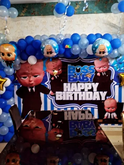 A Boss Baby themed home party setup, with a printed backdrop and matching table decor for a cohesive look.
