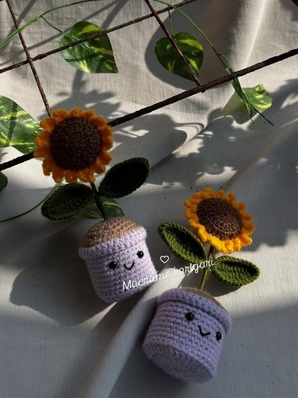 Two of our smiling lavender-colored mini pots, basking in the sun. The cute faces add an extra touch of personality and charm.
