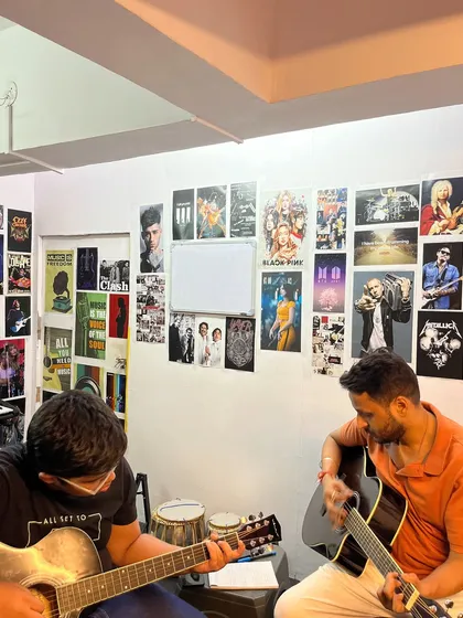 Looking for a creative outlet? A guitar lesson in progress, with our instructor guiding a student. Our studio is a welcoming space to explore your musical talents.