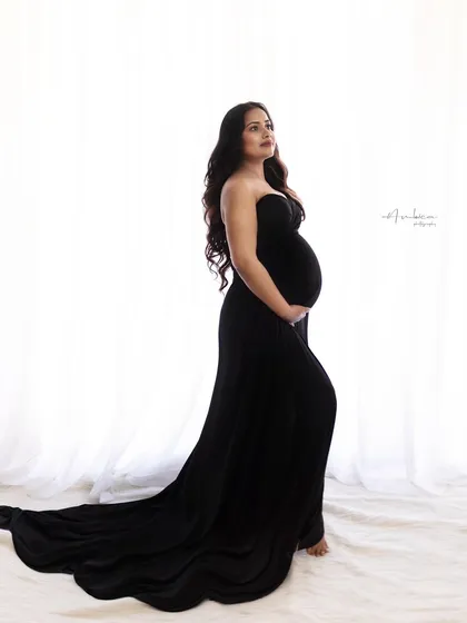 A duplicate of image 10, this classic black and white profile shot is a testament to timeless elegance. The focus is entirely on the silhouette and the anticipation of motherhood.