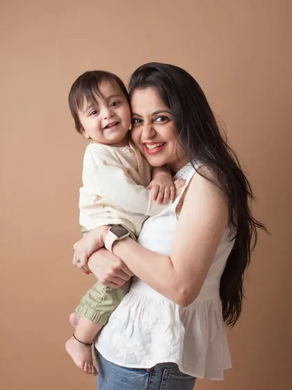 A sweet and happy portrait of a mother and her child, their smiles lighting up the frame.