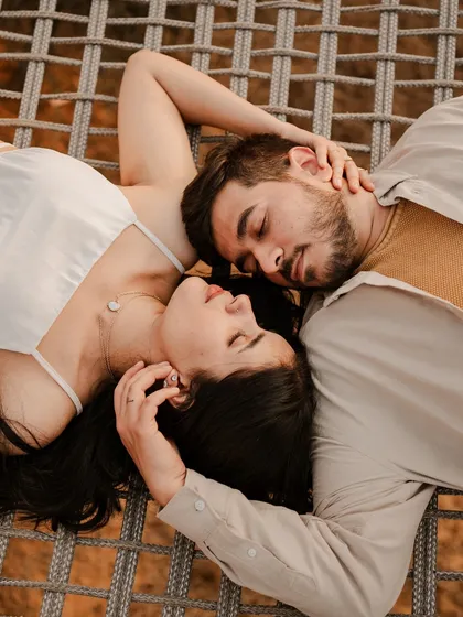 Sometimes the most beautiful moments are the quiet ones. This intimate overhead shot focuses on the simple, peaceful connection between a couple, proving that you don't need grand poses to tell a powerful love story.
