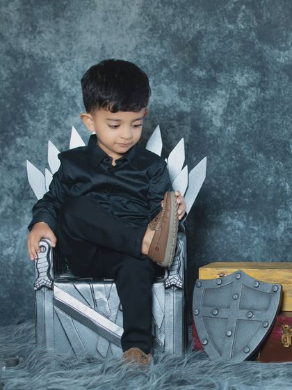 This little king is checking his shoes, a cute and candid moment during our Game of Thrones-themed shoot.